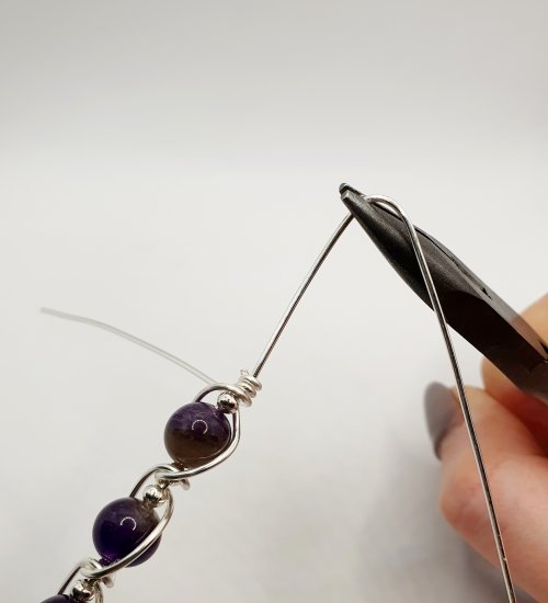 Natalie Patten's Gemstone and Spacer Bead Bangle - , Contemporary Wire Jewelry, Wire Wrapping, Wrapping, Wire Wrapping Jewelry, Beads, , Position your chain nose plies on the central wire about an inch away from the wrap above the last beads