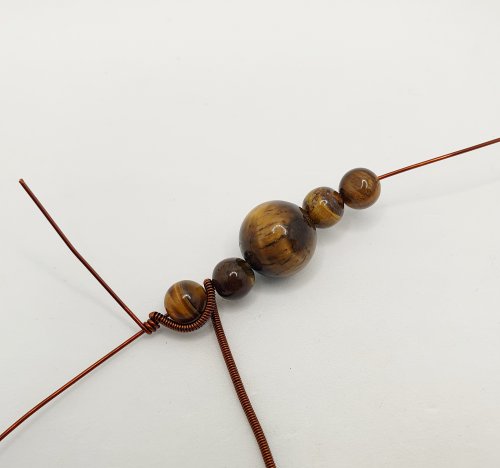 Natalie Patten's Pawprint Pendant and Earrings - , Contemporary Wire Jewelry, Coiling, Coiling Wire, Wire Coiling, Wire Wrapping, Wrapping, Wire Wrapping Jewelry, wrap the coil around the base wire between the beads